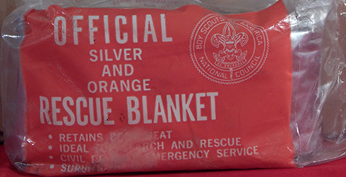 Used First Aid Rescue Blanket Silver and Orange; used by Scouts and Scouters as personal first aid kit for camping, hiking and other activities